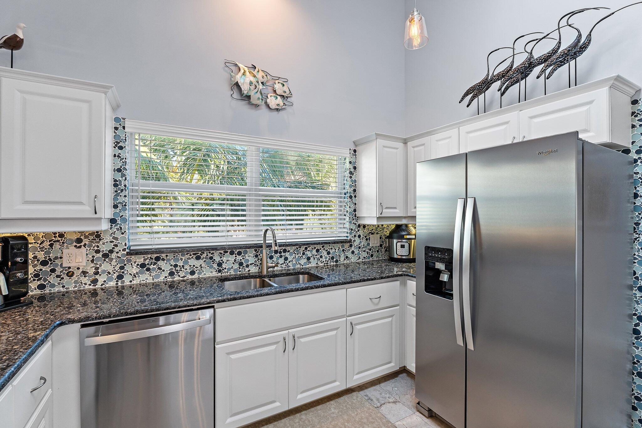 4161 U.S. Highway 1, Unit G3 Jupiter, FL 33477 - Photo 12 of 71 a kitchen with stainless steel appliances granite countertop a sink and a refrigerator
