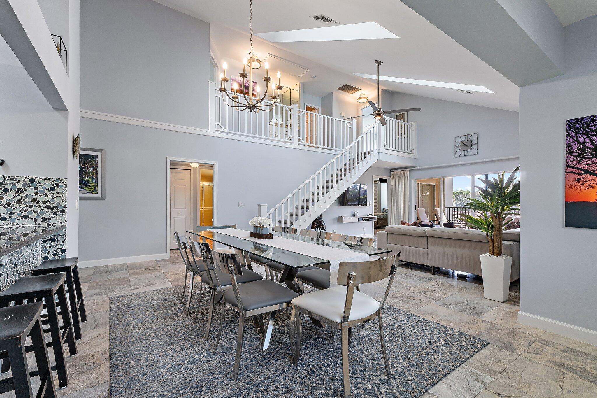 4161 U.S. Highway 1, Unit G3 Jupiter, FL 33477 - Photo 19 of 71 a view of a dining room with furniture and a chandelier