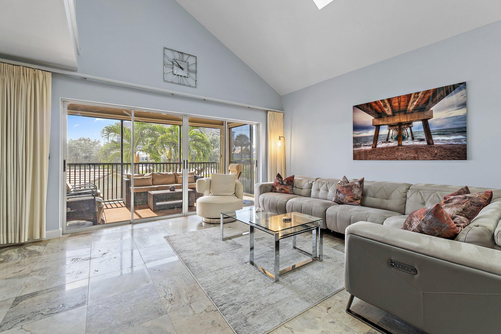 4161 U.S. Highway 1, Unit G3 Jupiter, FL 33477 - Photo 21 of 71 a living room with furniture and a floor to ceiling window