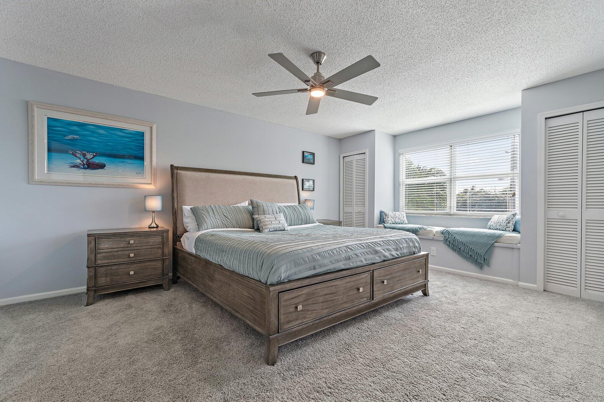 4161 U.S. Highway 1, Unit G3 Jupiter, FL 33477 - Photo 26 of 71 a bed sitting in a spacious bedroom next to a window