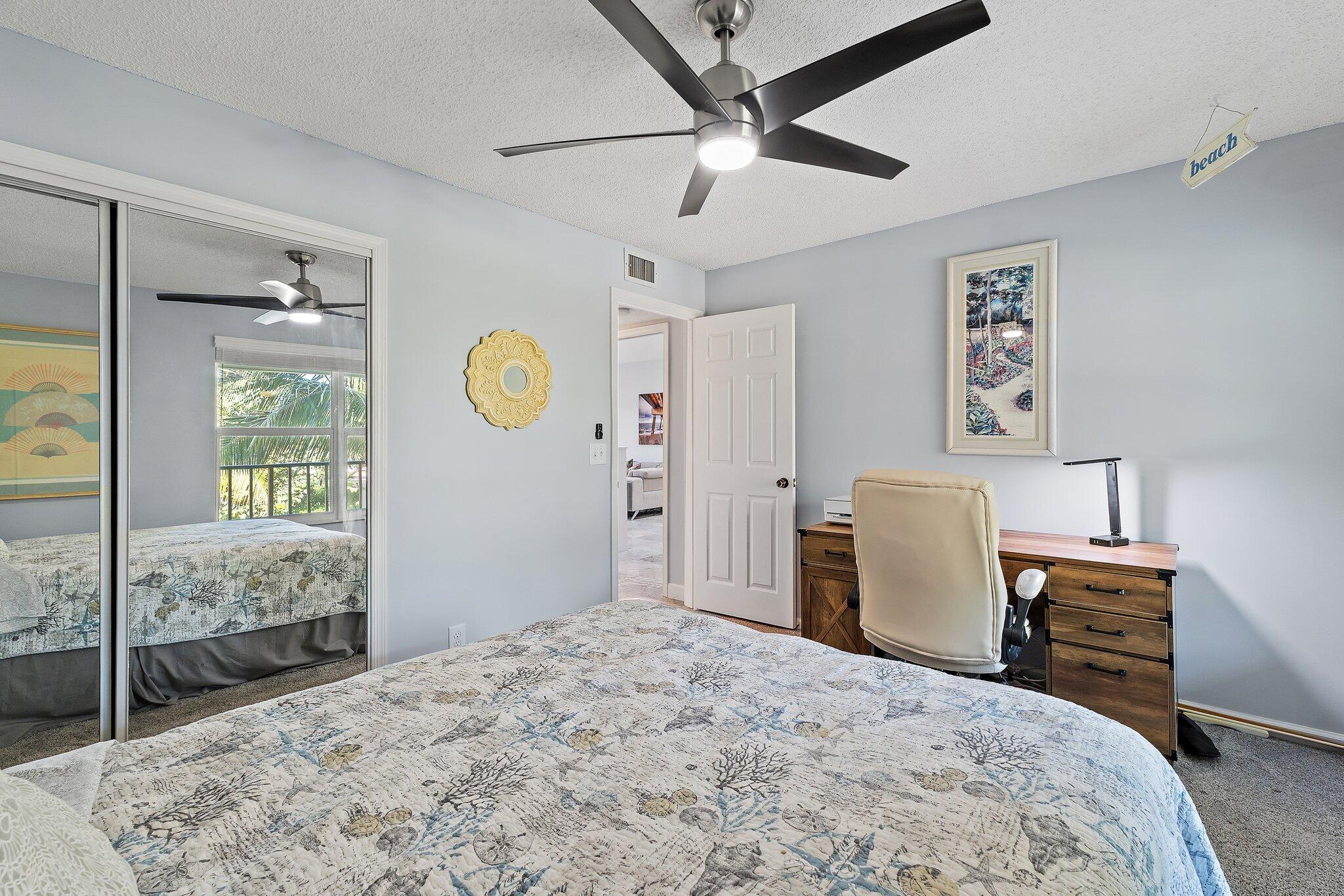 4161 U.S. Highway 1, Unit G3 Jupiter, FL 33477 - Photo 38 of 71 a bedroom with a bed and a chandelier