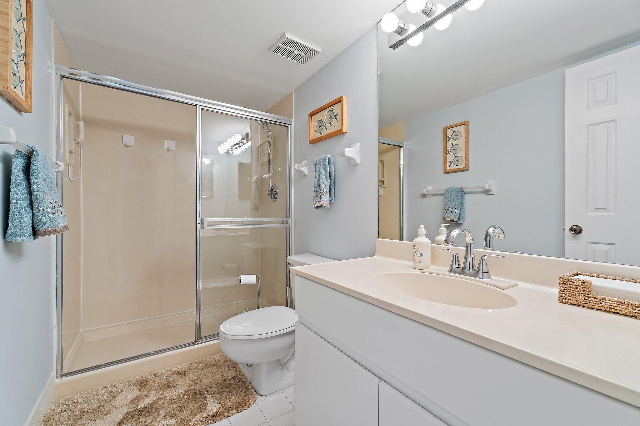 4161 U.S. Highway 1, Unit G3 Jupiter, FL 33477 - Photo 40 of 71 a bathroom with a sink a toilet and shower