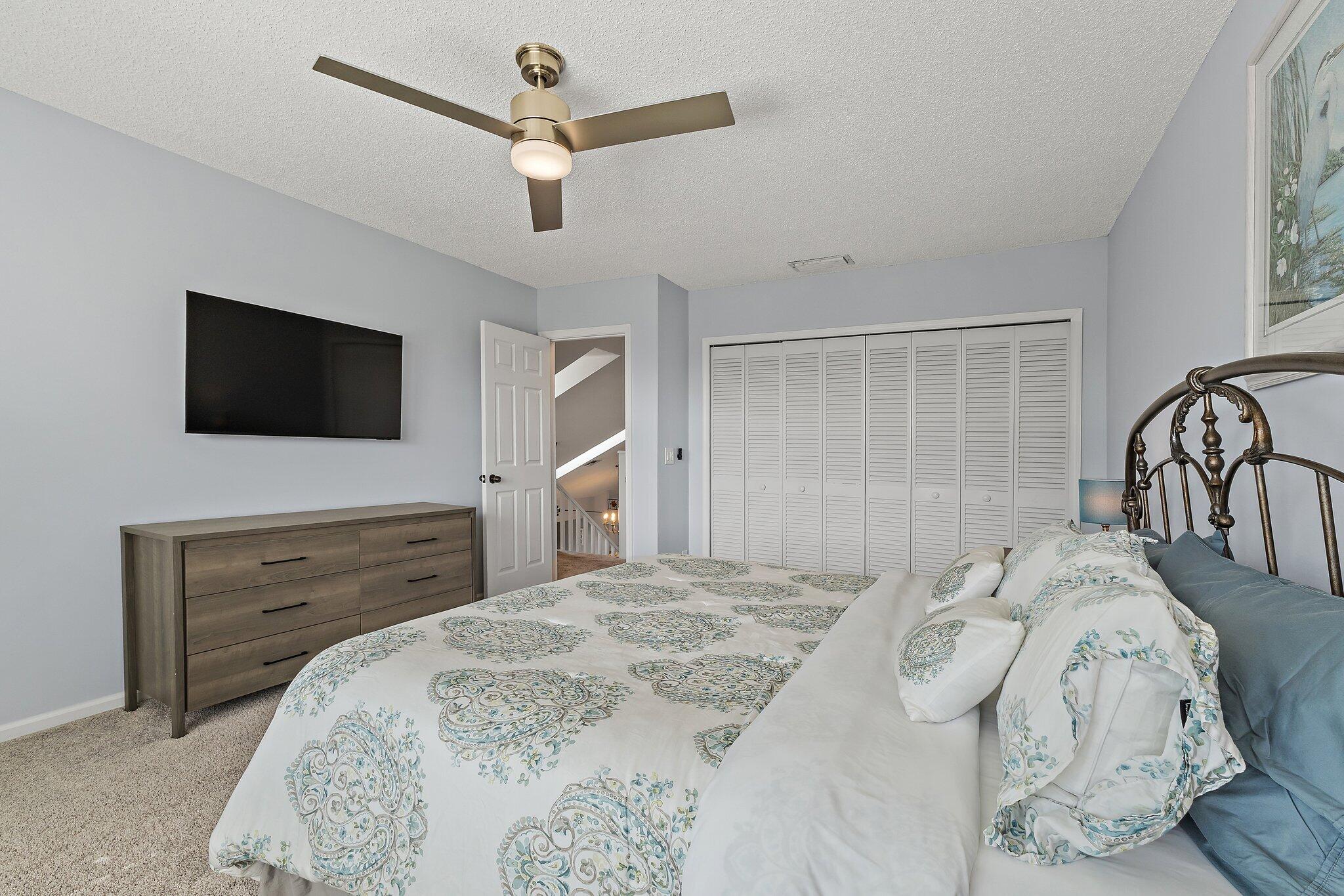 4161 U.S. Highway 1, Unit G3 Jupiter, FL 33477 - Photo 45 of 71 a bedroom with a bed and a flat screen tv