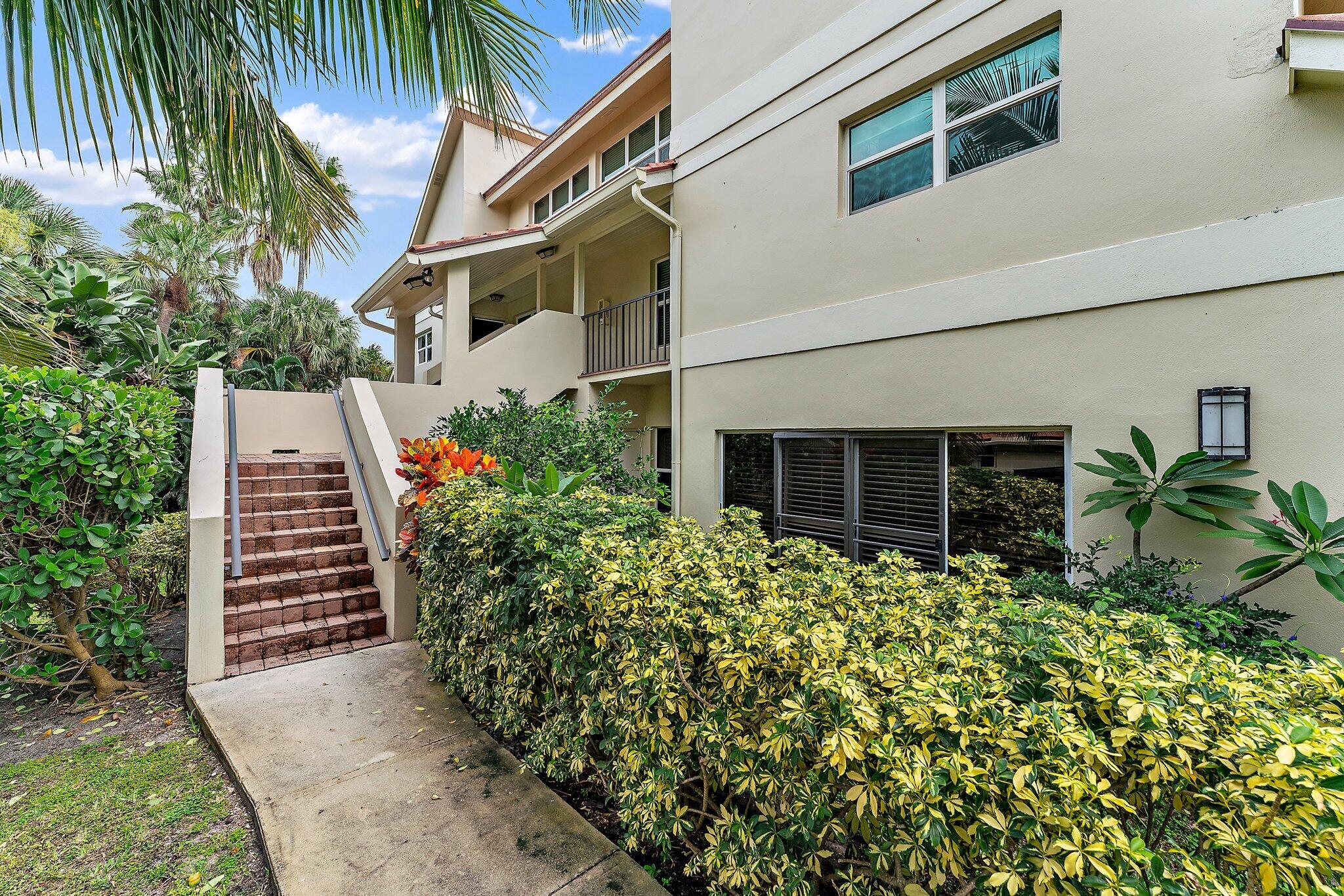 4161 U.S. Highway 1, Unit G3 Jupiter, FL 33477 - Photo 5 of 71 a backyard of a house with potted plants and brick wall