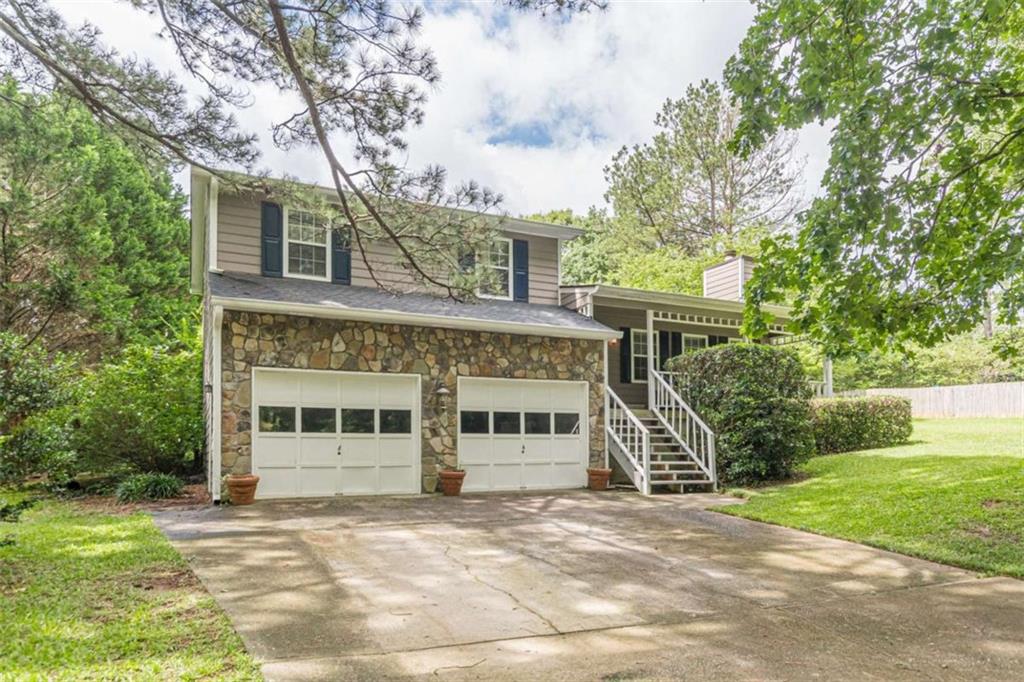 a front view of a house with a garden