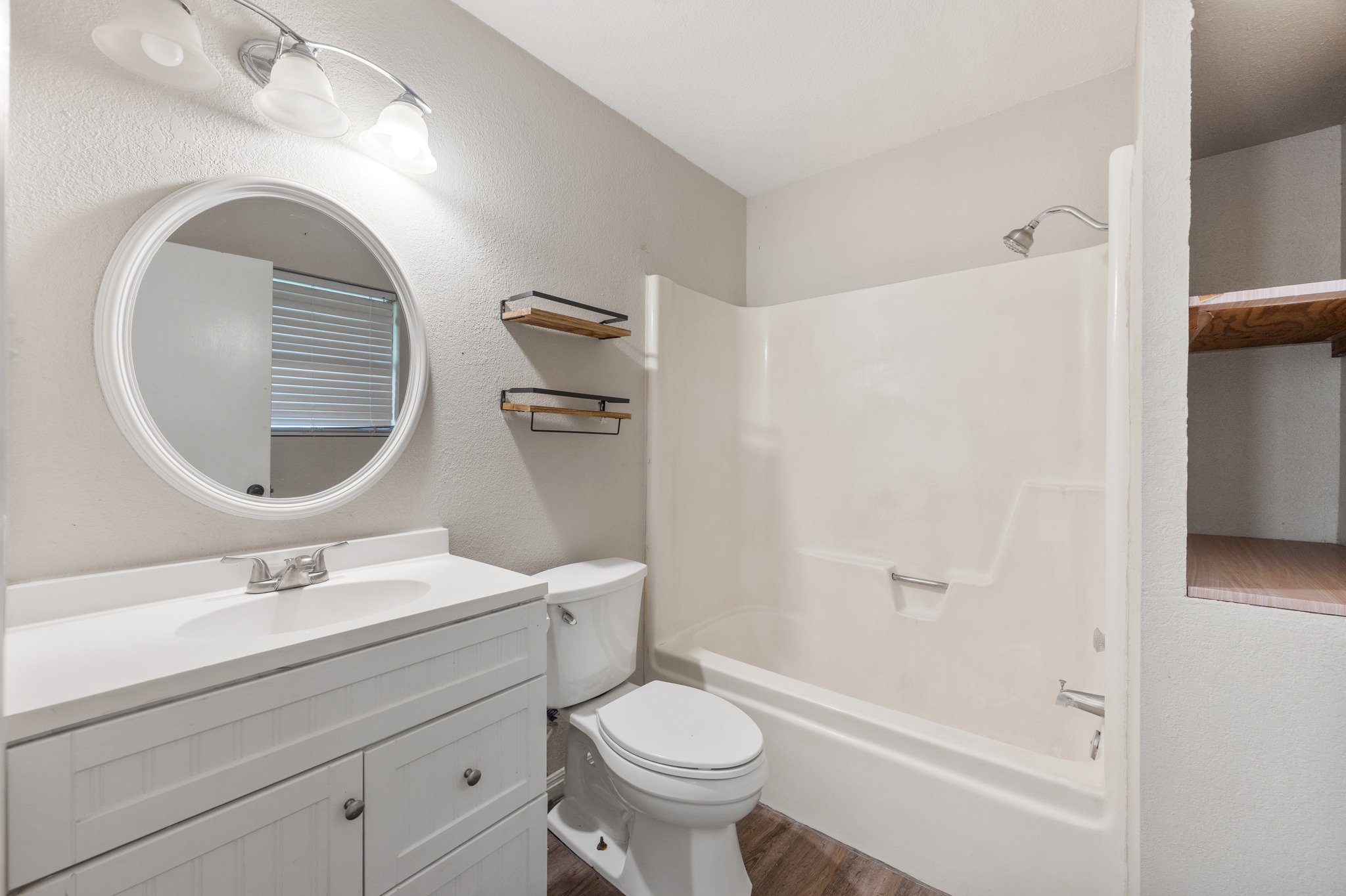 110 Skyview Terrace Leander, TX 78641 - Photo 17 of 26 Full bathroom featuring a white vanity with integrated sink, chrome faucet, and round framed mirror