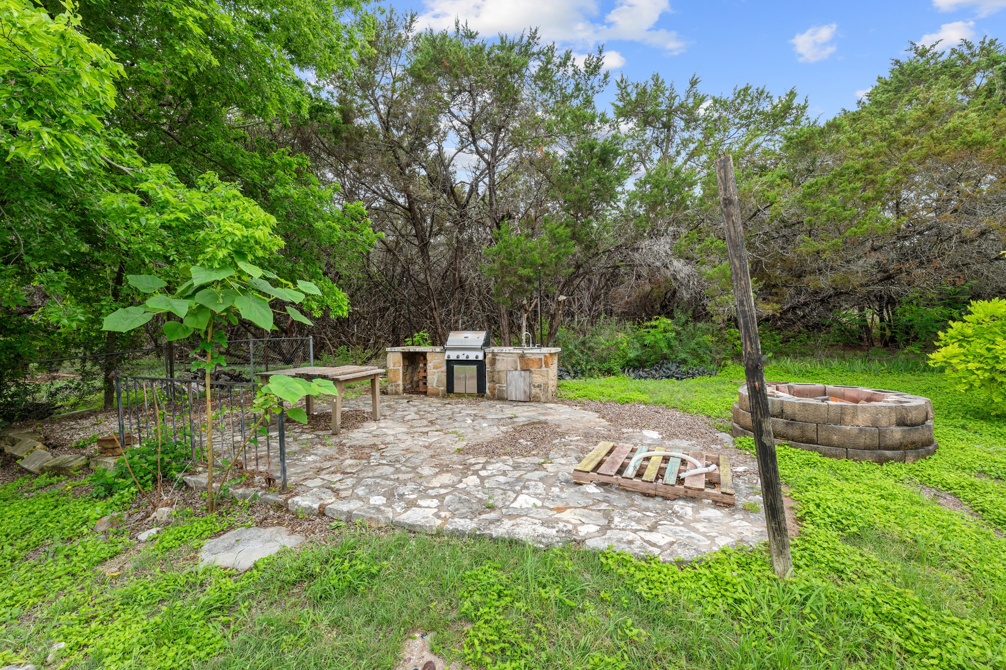 110 Skyview Terrace Leander, TX 78641 - Photo 24 of 26 Outdoor entertaining area featuring a stone patio, built-in BBQ station, and a stone fire pit