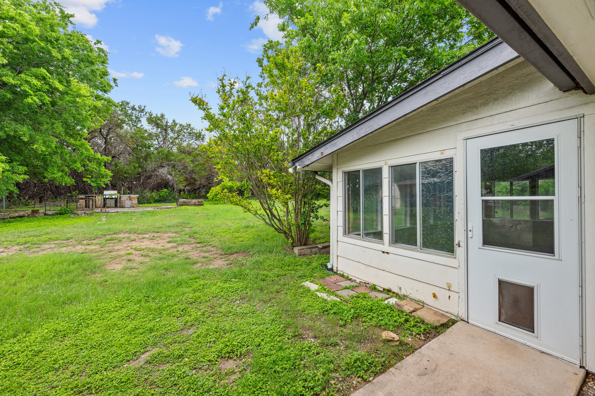 110 Skyview Terrace Leander, TX 78641 - Photo 26 of 26 Expansive green space featuring mature trees and a dedicated outdoor cooking area