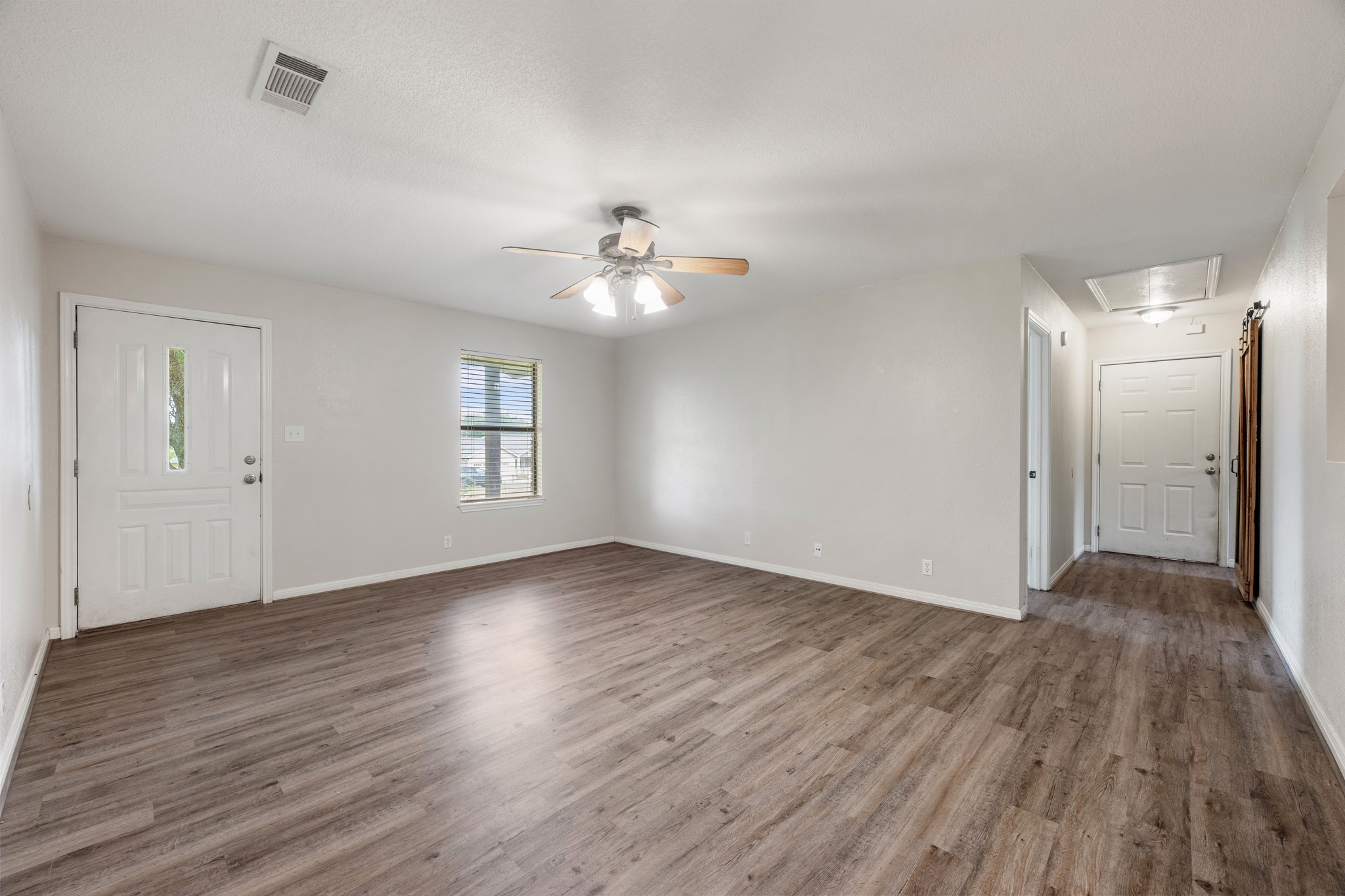 110 Skyview Terrace Leander, TX 78641 - Photo 6 of 26 Spacious interior featuring wood-finish flooring, a ceiling fan with integrated lighting, and multiple panel doors