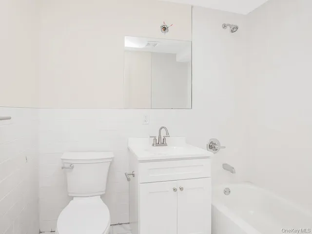 a bathroom with a sink a toilet and bathtub