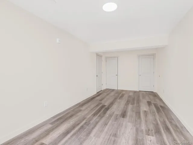 a view of an empty room and wooden floor
