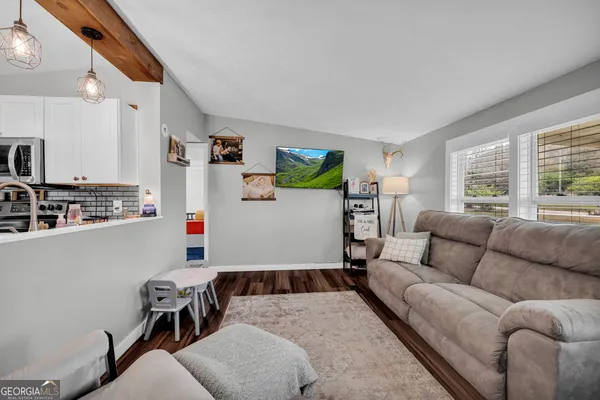 a bedroom with a bed couch and a window
