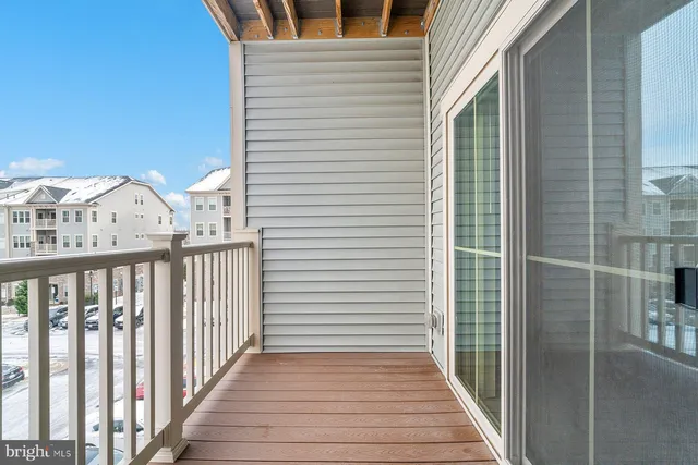 a view of a balcony with wooden floor