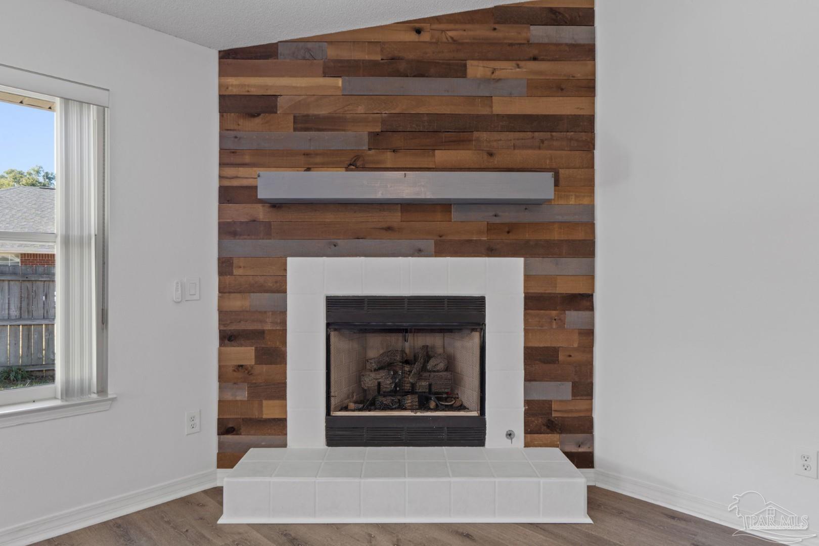 11841 Old Course Road Cantonment, FL 32533 - Photo 12 of 46 a living room with a fireplace and a fireplace