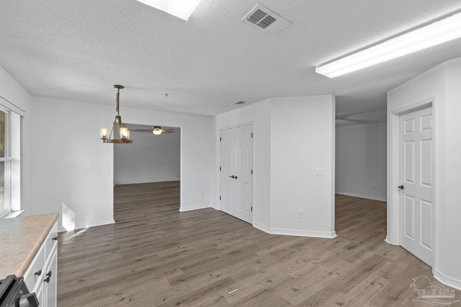 11841 Old Course Road Cantonment, FL 32533 - Photo 19 of 46 an empty room with wooden floor and windows