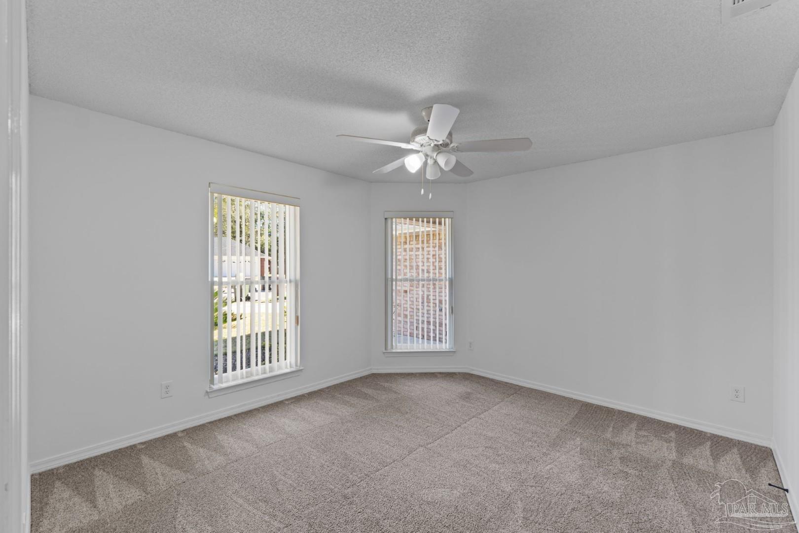 11841 Old Course Road Cantonment, FL 32533 - Photo 23 of 46 an empty room with windows and fan