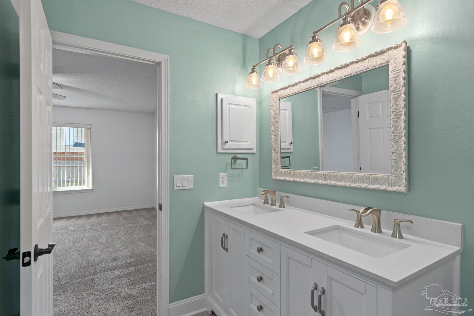 11841 Old Course Road Cantonment, FL 32533 - Photo 34 of 46 a bathroom with a sink vanity and mirror