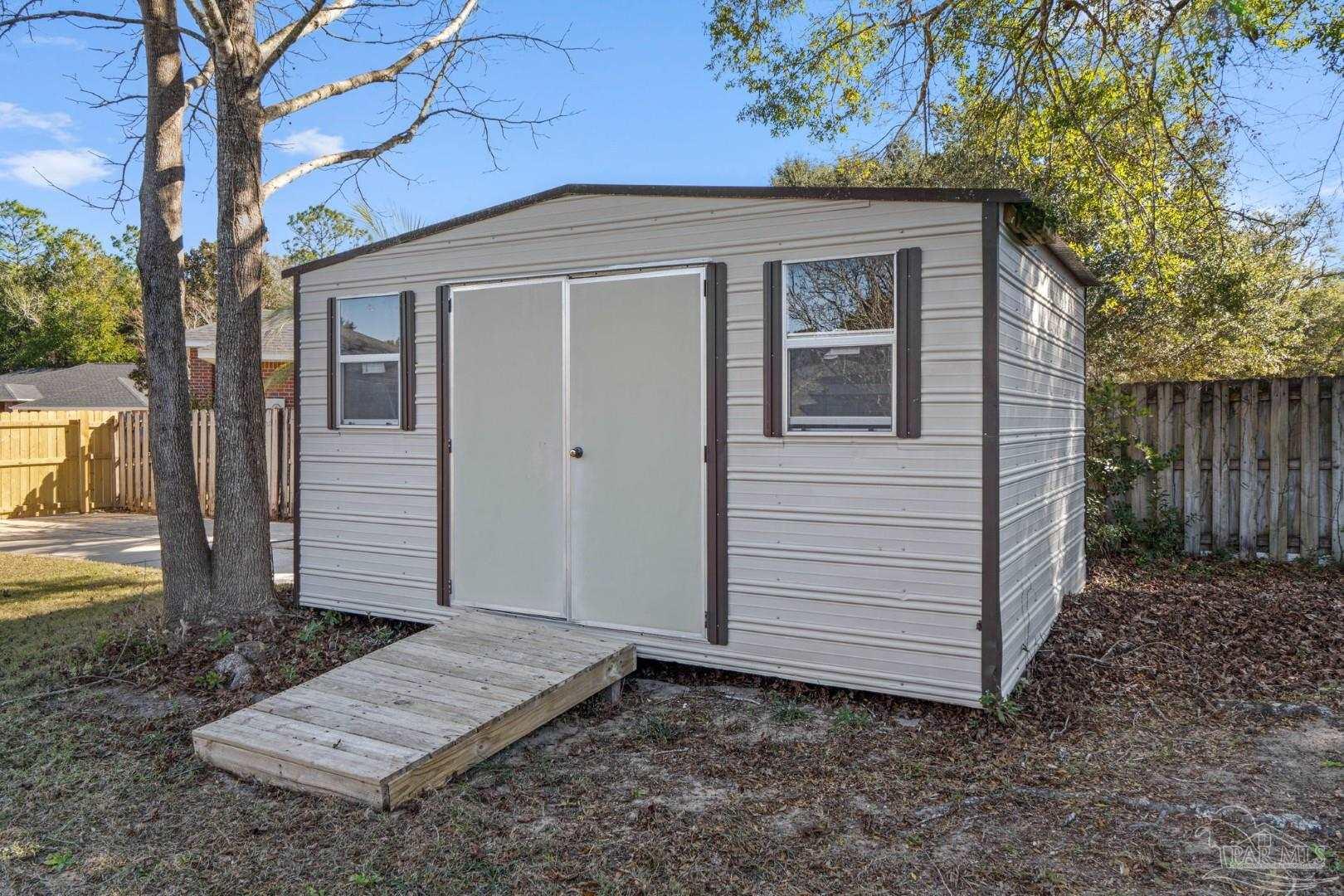 11841 Old Course Road Cantonment, FL 32533 - Photo 44 of 46 a front view of a house with a yard