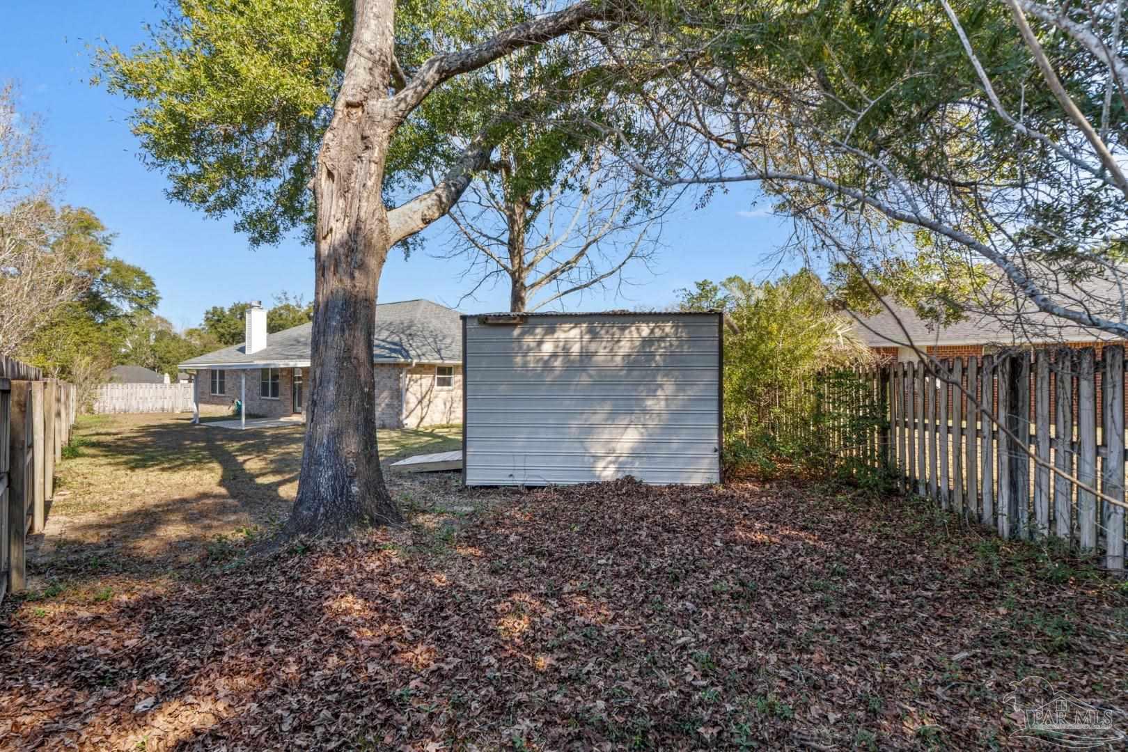 11841 Old Course Road Cantonment, FL 32533 - Photo 45 of 46 a view of a yard with a tree in the background