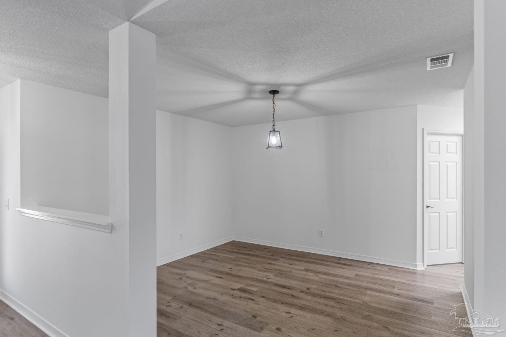 11841 Old Course Road Cantonment, FL 32533 - Photo 7 of 46 a view of empty room with wooden floor