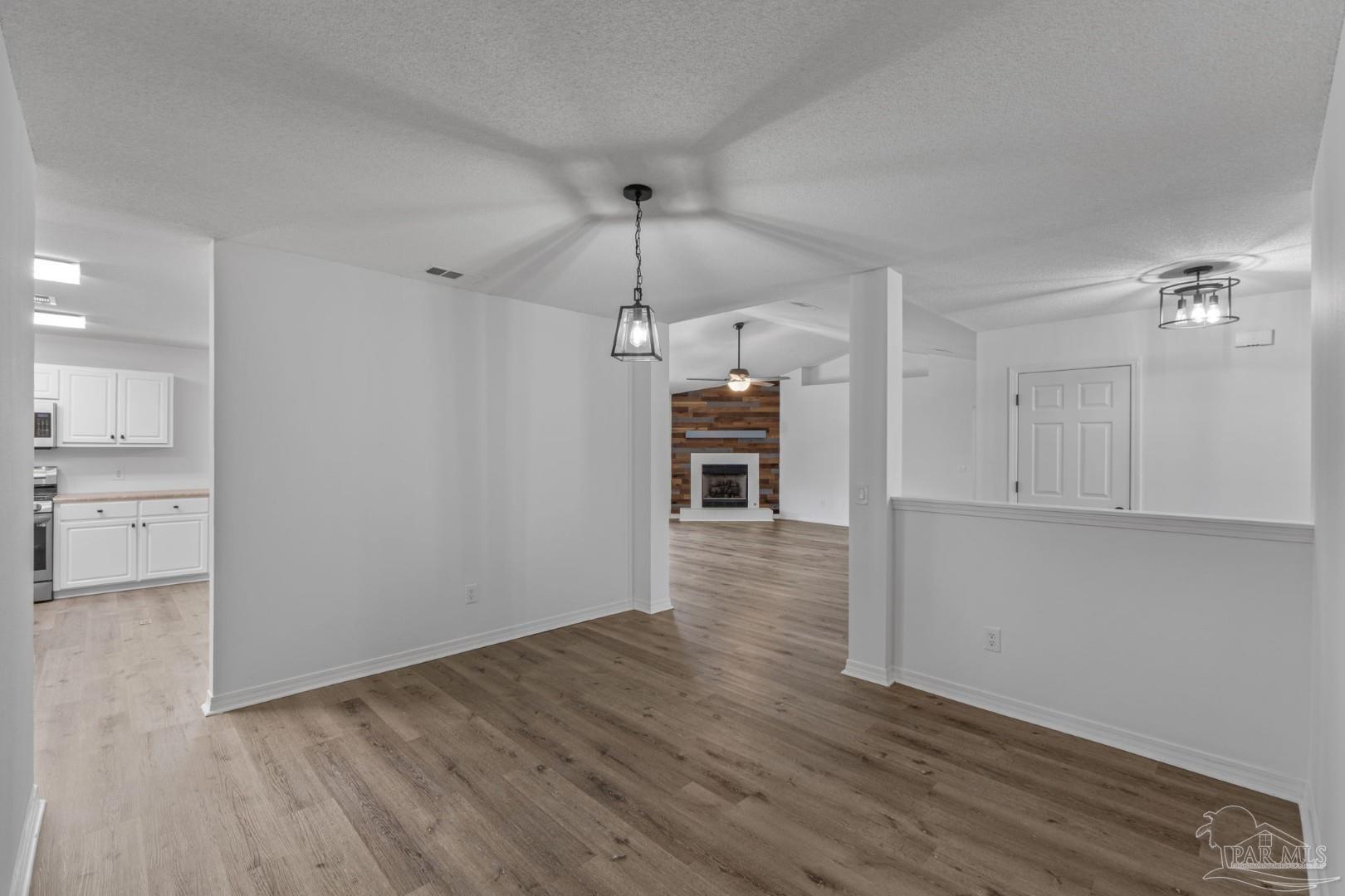 11841 Old Course Road Cantonment, FL 32533 - Photo 9 of 46 a view of a kitchen with wooden floor and a window