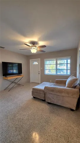 a bedroom with a bed and a ceiling fan
