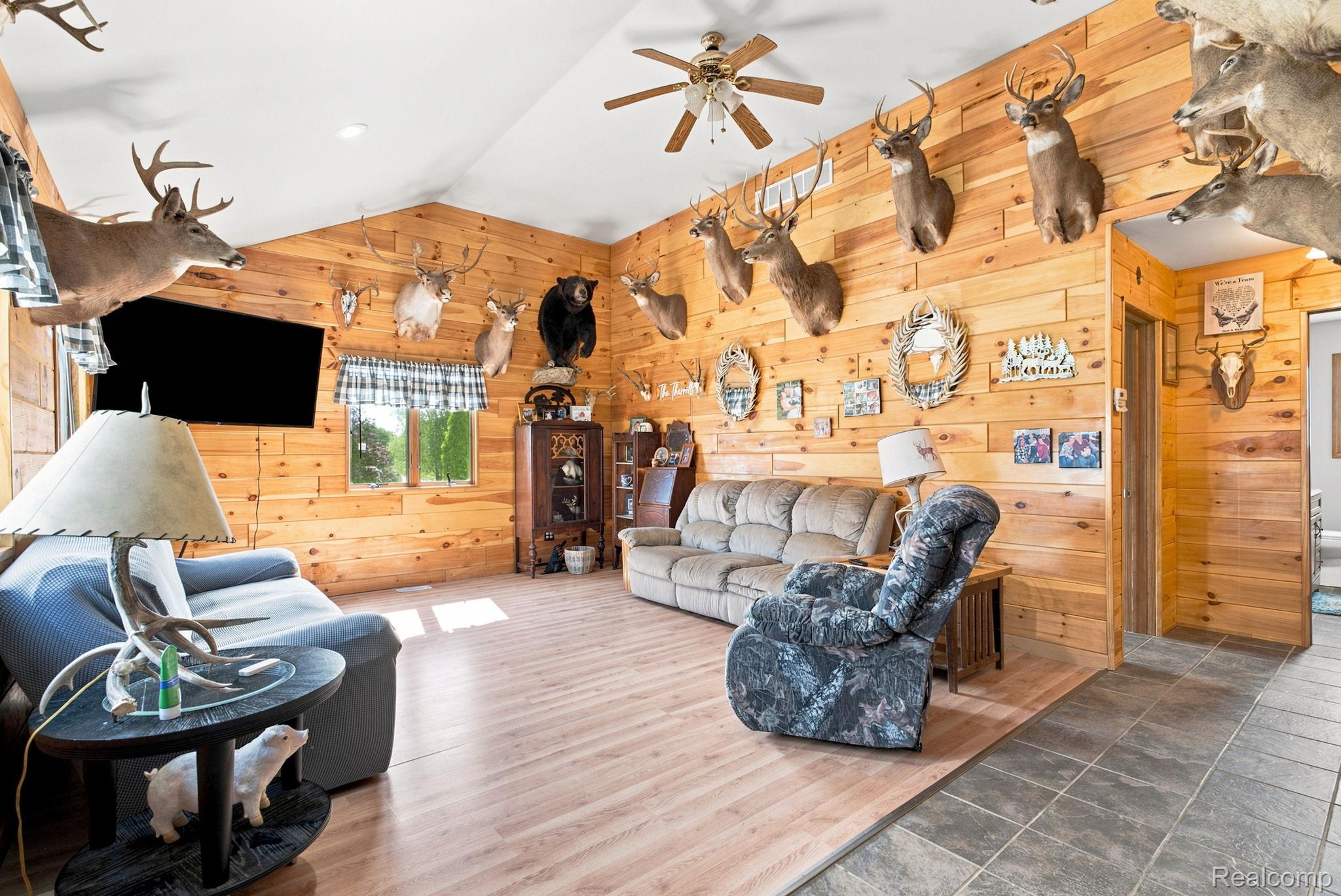 4201 Galbraith Line Road Croswell, MI 48422 - Photo 3 of 39 Spacious living area featuring extensive wood plank wall finishes and wood-finish flooring