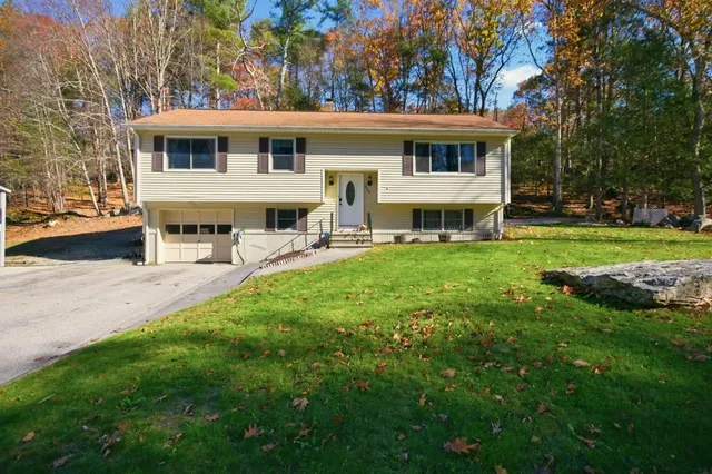 a view of a house with a backyard and a patio