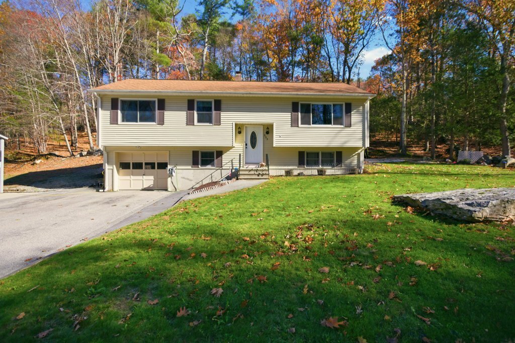 a view of a house with a backyard and a patio