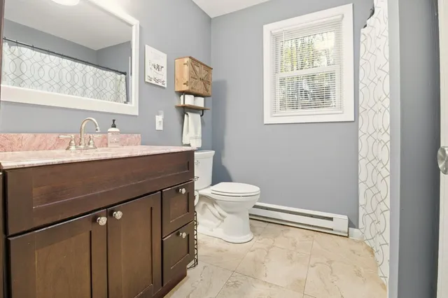 a bathroom with a sink a toilet and a mirror
