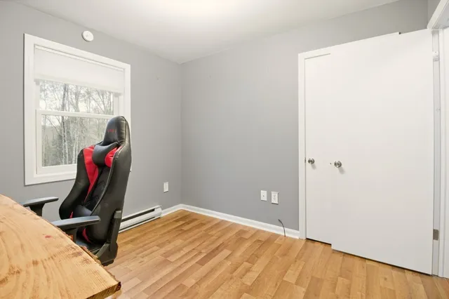 a view of workspace with wooden floor and windows