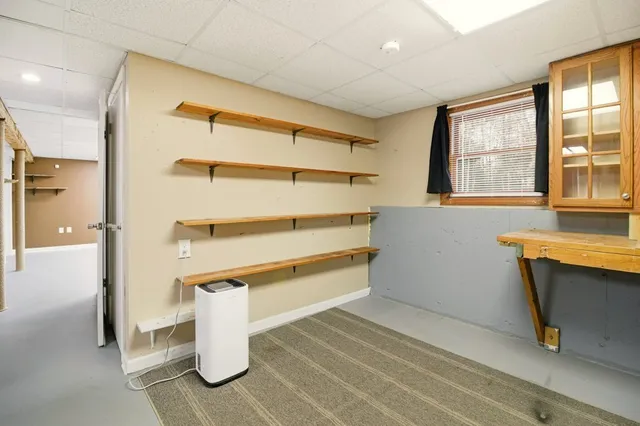 a storage room with wooden floor and windows