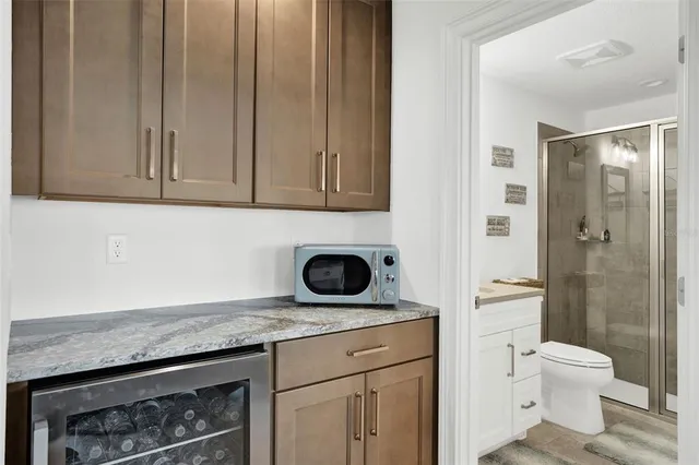 a bathroom with a granite countertop sink a toilet and shower