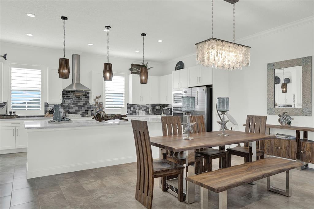 7 Marden Drive Ormond Beach, FL 32176 - Photo 22 of 68 a dining table with chairs and kitchen view
