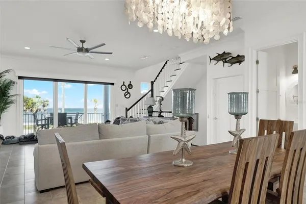 a view of a dining room with furniture and chandelier