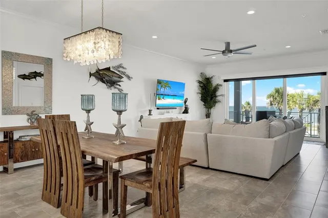 a kitchen with stainless steel appliances kitchen island granite countertop a sink a stove and a wooden floors