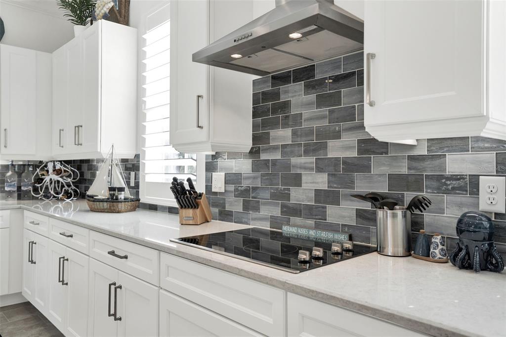 7 Marden Drive Ormond Beach, FL 32176 - Photo 31 of 68 a kitchen with granite countertop white cabinets and white appliances