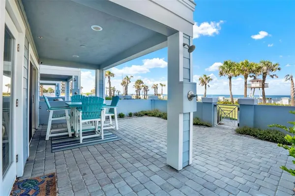 a view of a patio with table and chairs with wooden floor and fence
