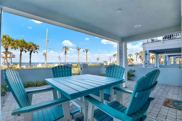 a view of a patio with table and chairs and potted plants