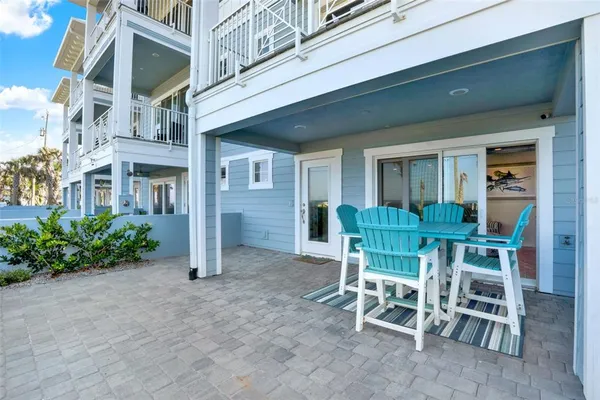 a view of a porch with chairs and tables