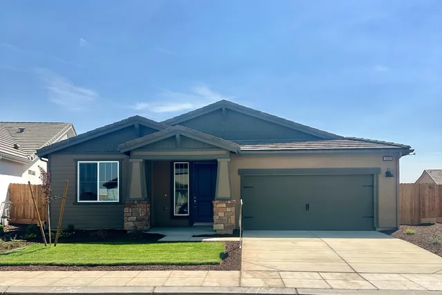 a view of a brick house with a yard