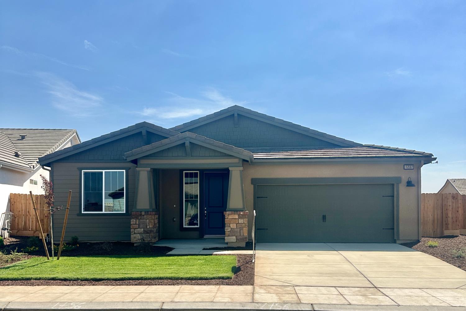 1237 Cathedral Court South Madera, CA 93636 - Photo 1 of 8 a view of a brick house with a yard