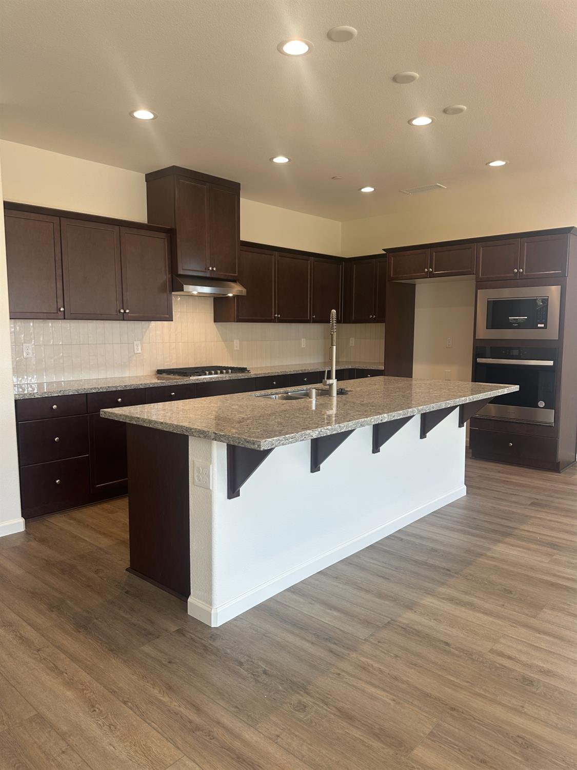 1237 Cathedral Court South Madera, CA 93636 - Photo 4 of 8 a kitchen with kitchen island a sink appliances and cabinets