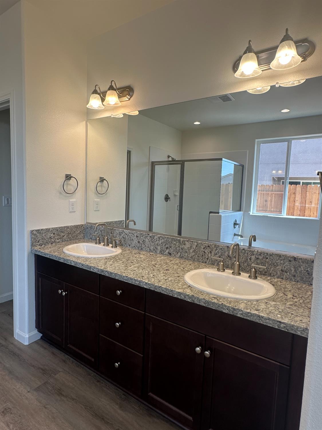 1237 Cathedral Court South Madera, CA 93636 - Photo 6 of 8 a bathroom with a granite countertop double vanity sink and a mirror