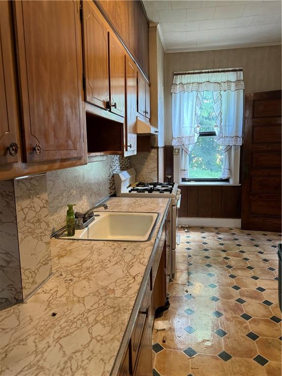 335 73rd Street Brooklyn, NY 11209 - Photo 4 of 5 a kitchen with a sink a stove and a microwave