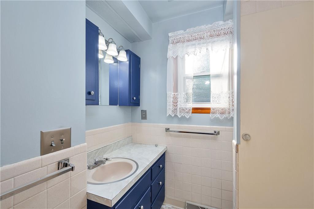 112 Elise Drive Butler, PA 16001 - Photo 18 of 32 a bathroom with a granite countertop sink and a mirror