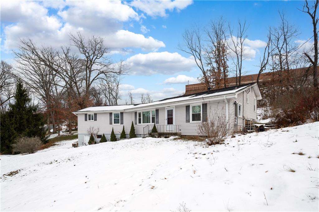 112 Elise Drive Butler, PA 16001 - Photo 2 of 32 a front view of a house with a yard covered in snow