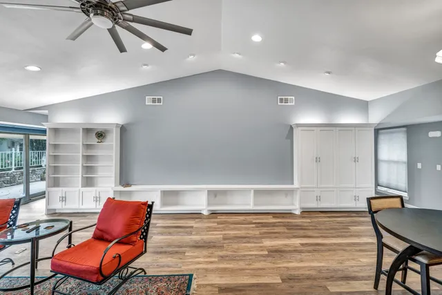 a workspace with wooden floor and furniture