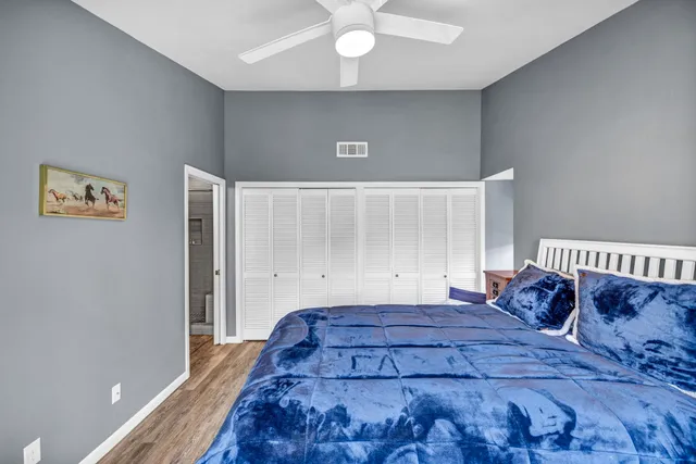 a bedroom with a large bed and a chandelier