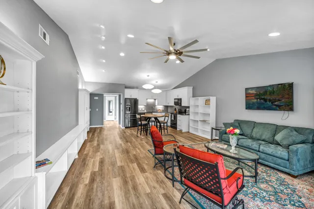 a living room with furniture and wooden floor
